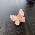 Detail of pink marble textured butterfly hair claw with durable metal spring mechanism - Iridescent Milk Tea