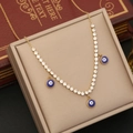 Collana dorata in acciaio con ciondoli occhio blu e zirconi disposta in una scatola per gioielli - Stile Occhio Tondo (4#)