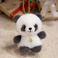 Cute panda plush keychain with green leaf pendant and bead strap on soft carpet - Panda / 15CM