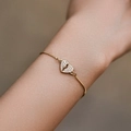 Adjustable gold plated bracelet featuring a broken heart pendant with clear zircons - Pave Broken Heart (KB0594)