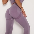 Detail view of purple seamless yoga pants featuring ribbed texture and butt-lifting design - Purplish Red