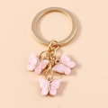 Pink acrylic butterfly keychain pendant with gold metallic finish on a cream background - Pink White Pearly (YZ172fenbai)