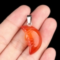 Hand carved orange agate moon face pendant with silver bail shown for size comparison - Red Agate