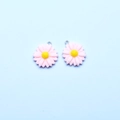 Detailed view of pink and yellow resin sunflower pendants with silver metal rings - Peach
