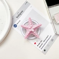 Close-up of pink starfish phone grip holder with matte texture on a stylish white desk - Magnetic Stand / Pink