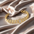 Minimalist interlocking oval ring bangle in a matte golden finish on silk fabric - f35 Linked Oval Style / Gold