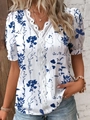 Close-up of white V-neck shirt featuring blue floral prints and intricate lace trim detailing - S / White with Navy Floral