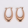 Detail shot of rose gold U-shaped earrings with elegant vertical striped texture - Rose Gold