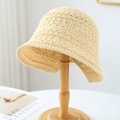 Minimalist straw bucket hat in cream white featuring refined woven texture on a wood stand - M (56-58cm) / Lotus Wave Edge Style (5642) / Beige