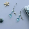 Blue dolphin beaded phone strap with sea shell charms and pearls on a white background - Summer Dolphin