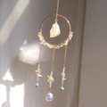 Detail of golden metal ring with raw crystal and iridescent star prism pendant - Citrine