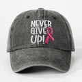 Detailed view of NEVER GIVE UP embroidery and pink ribbon on washed cotton baseball cap - Black