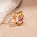 Detail of irregular gold lava ring with oval purple zircon on warm stone background - Gold Square