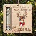 Close-up of wooden reindeer money holder ornament hanging on a festive Christmas tree - 3