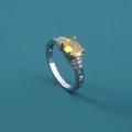 Macro shot of silver ring featuring a yellow oval gemstone and zircon micro-pave detailing - Adjustable Open / Yellow Oval Gemstone/Hollow Diamond Band
