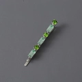 Detail of silver hair clip featuring round green and rectangular light green crystals - Silver Green