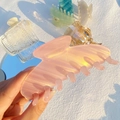 Close-up of pink pearlescent hair claw clip showing a glossy striped acetate finish - Colorful Jelly Pink