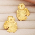 Macro view of gold-plated layered petal stud earrings on beige velvet tray - Lotus Leaf Studs