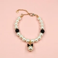 Detail of beaded pet necklace with white faux pearls and black bow pendant with gold clasp - XS / Black & White Pearl Necklace