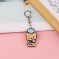 Cute acrylic brown bear keychain with blue chef hat and silver metal clasp hanging - Noodle Eating Bear