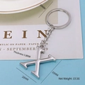 Polished silver letter X keychain with measurements 28mm by 35mm and metal ring - Letter-X