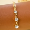 Golden belly button ring featuring three round white zircons and shimmering pave accents - Triple Rhinestone (Gold White)