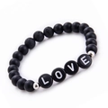 Detail of matte black stone beads and LOVE alphabet charms on a beaded couple bracelet - Matte Stone Bracelet
