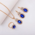 Golden bridal jewelry set featuring dark blue crystals and diamond accents - Three-Piece Set / Oval-Blue