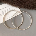 Minimalist large silver hoop earrings with a polished finish on textured background - Style 60 / Diameter 69mm / Silver