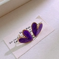 Dettaglio di orecchini a cuore in smalto viola con bordo dorato su tessuto bianco - Viola (Motivo Marmo)