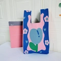 Detailed close-up of blue knit tote bag with pink tulip and green leaf floral pattern - Tulip Royal Blue