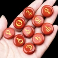 Solar system planet symbols set engraved on round red jasper stones held in hand - Red Jasper