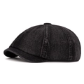 Washed black denim newsboy cap featuring vintage octagonal paneling and a short brim - Black