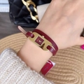 Detail showing red leather wrap-around strap and golden padlock-shaped watch on wrist - Oval Double-Wrap Leather Strap