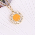 Gold sunflower necklace with orange enamel smiley face and zircon inlay on white shell - Orange