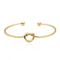 Polished gold knot open bangle bracelet with metallic sphere ends and mirror finish - Gold