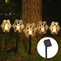 Outdoor solar snowflake stake lights with 5 LED heads emitting a warm glow for garden decor - Snowflake Solar (5-in-1 Warm White)
