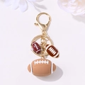 Golden American football keychain featuring brown resin charms and decorative beads - Gold Football Multi Pendants Style