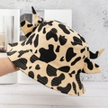 Detail shot of creative black and yellow cow print bucket hat with cute horn accents - Cow Khaki