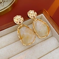 Detail of vintage irregular gold earrings with marble resin in a wooden jewelry box - White (Silver Earring Post)