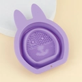 Purple bunny-shaped silicone makeup brush cleaning mat with textured surface and hanging hole - Purple
