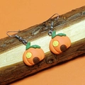 Cartoon pumpkin house resin earrings in bright orange with green accents and metal hooks - Pumpkin House with Yellow Windows
