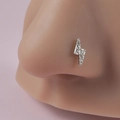 Silver lightning bolt nose stud with clear crystals on a model with pink background - White Lightning