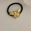 Minimalist elastic hair tie with a textured gold metal knot and premium black cord - Glossy Knotted Style Gold