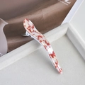Detail of a large red and white tortoiseshell acetate hair claw clip on a gray tray - 5# Red & White Pearlescent Curved Horn Clip