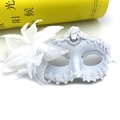 Close-up of white masquerade mask with lace, silver sequins, large silk flower and feathers - One Size / White