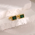 Detailed close-up of 18K gold plated earrings with emerald green rectangular zircon stones - 18K Gold / Blue