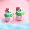 Close-up of resin cupcake miniatures with green cake and pink base on wood background - Star & Heart Cupcake - Pink Base