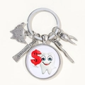 Detailed close-up of tooth theme keychain with toothpaste and toothbrush charms - Style 6 (Money Sign Tooth)