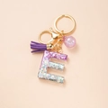 Glitter resin letter E keychain with purple tassel and gold hardware for women - Letter E